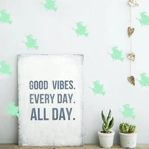 Luminous Halloween wizard wall stickers on a white wall near succulent plants