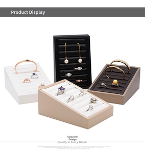 Detailed view of multi-tier jewelry display stands in various colors for rings and earrings