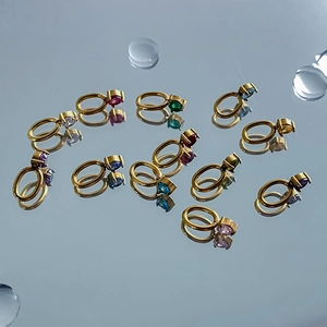 Macro view of 12 colorful cubic zirconia birthstone pendants in gold stainless steel