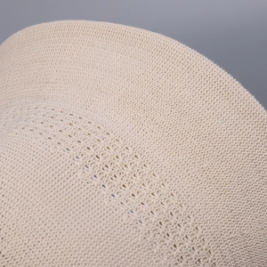Close-up of the delicate knit texture and breathable pattern of the beige sun hat