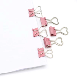 Pink heart shaped binder clips in metal finish organized on paper for office use
