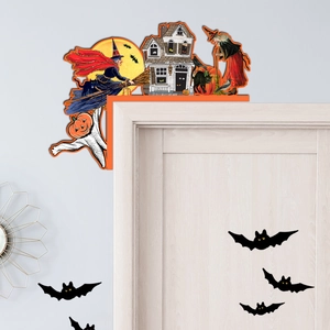 Macro detail of a vintage wooden Halloween door corner sign with witch and haunted house motifs