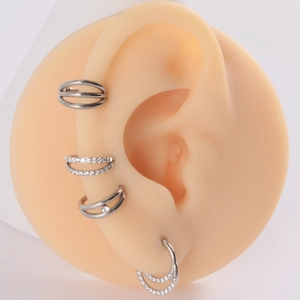 Titanium and steel nose ring set with moon and zircon accents shown on model ear