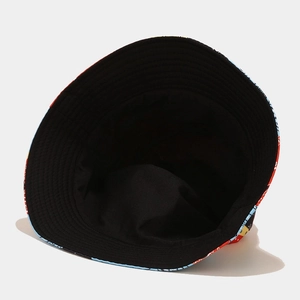 Detail view of double-sided bucket hat featuring black lining and colorful cashew floral print
