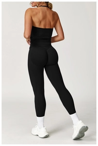Rear view of seamless black yoga set featuring racerback top and butt lifting leggings
