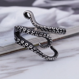 Vintage silver octopus tentacle open ring with realistic suction cup texture on marble