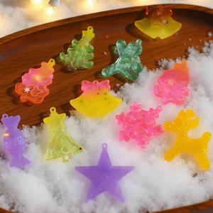 DIY Christmas resin charms with ginger bread and tree shapes on snowy wooden tray
