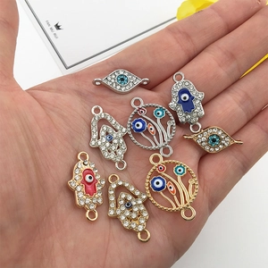 Hamsa Hand and Evil Eye charms in gold and silver finish with colorful enamel details