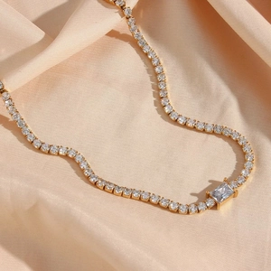 Detailed macro view of 18k gold plated tennis necklace with rectangular zircon stone