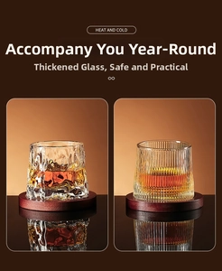 Detail of thickened glass tumblers with hammered and ribbed textures on wooden coasters