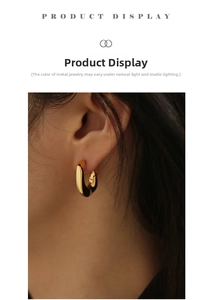 Close-up of minimalist 18K gold plated brass hoop earring worn on model's ear