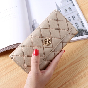 Detail of champagne gold quilted PU leather wallet featuring a heart crown metal buckle