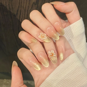 Almond cat-eye press-on nails with 3D white floral accents and shimmering gradient effect