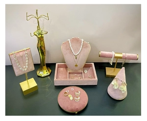 Detail of luxury jewelry display stand with gold necklaces and pearl earrings