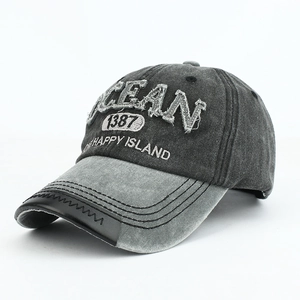 Close-up of vintage denim baseball cap with OCEAN embroidery and contrast peak details