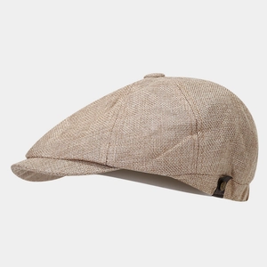 Close-up of breathable light brown linen newsboy cap with side leather buckle detail