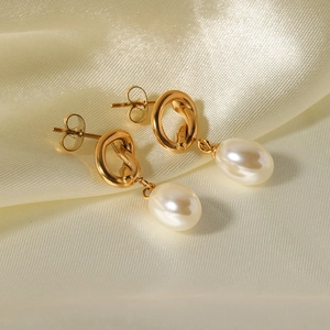 French vintage baroque pearl earrings with golden knot design on silk fabric