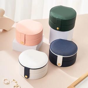 Portable cylindrical jewelry storage box in multiple colors with snap button closure