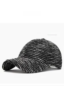 Detailed view of the black and white tweed texture on a stylish baseball cap
