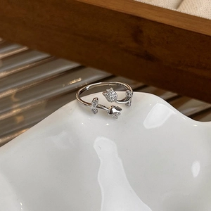 Macro shot of silver tulip ring featuring micro-pave crystals and adjustable open band