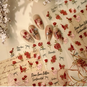 Detail of vintage red rose nail stickers with black bows and floral English lettering