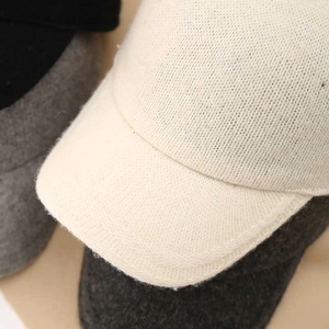 Close-up of wool-blend knit texture on a minimalist baseball cap with a curved brim