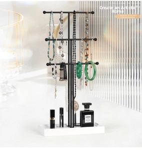 Three-tier black metal jewelry stand with white base tray for necklace storage
