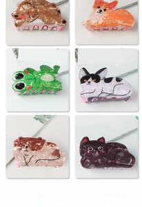 Macro detail of various animal-shaped acetate hair claws with marble texture