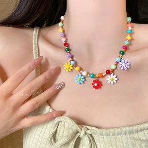 Close-up of colorful beaded daisy necklace with vibrant floral charms in dopamine style