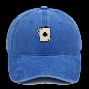 Detailed embroidery of playing cards Ace and Jack on a washed blue cotton baseball cap