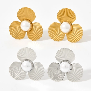 Elegant gold and silver scallop pearl stud earrings with textured petal metal design