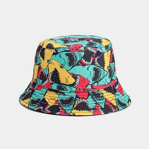 Detailed view of bucket hat with vibrant colorful shark print and durable canvas texture