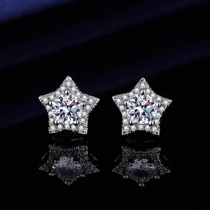 Macro shot of silver star-shaped stud earrings with sparkling pavé moissanite stones