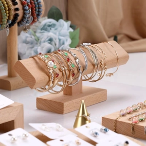 Solid wood T-bar stand displaying gold bracelets and pearl jewelry for retail store