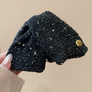 Detail of tweed hair claw with gold threads and Believe in Yourself metal button
