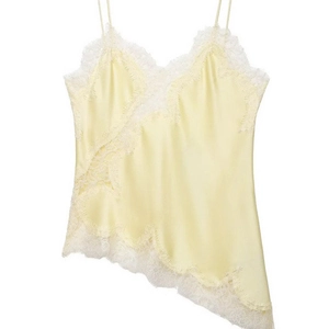 Pale yellow satin camisole with delicate white lace trim and asymmetrical hemline