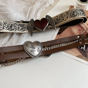 Vintage leather belts featuring printed wings and floral heart buckles in a retro punk style