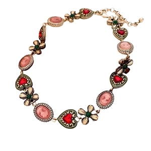 Vintage gold-tone bracelet with pink cameo portraits and colorful enamel heart links