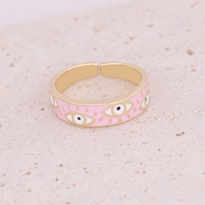 Macro detail of pink enamel evil eye ring with gold base and adjustable open band