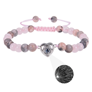 Detail of 6mm beaded projection bracelet showing heart pendant with I Love You in 100 languages