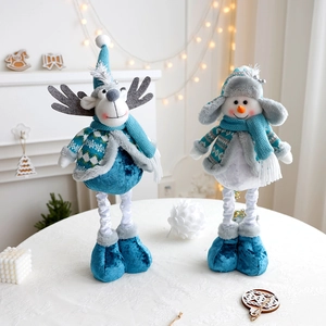 Detail of blue plush reindeer and snowman dolls with knitted hats and sparkling boots