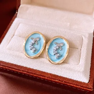 French luxury gold oval earrings with blue enamel, silver fish motif and white pearls