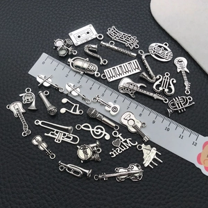 Macro view of antique silver music instrument charms including guitar and violin