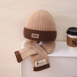 Detail of winter knitted hat and scarf set in khaki and brown with min label