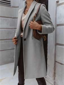 Detail of light grey wool blend coat showing the elegant lapel and button closure fit