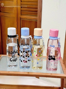 Detail of colorful portable water bottles with cartoon prints and detachable design