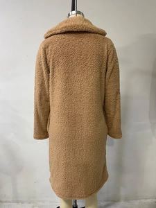 Rear view of a camel teddy fleece long coat with oversized lapels on a mannequin