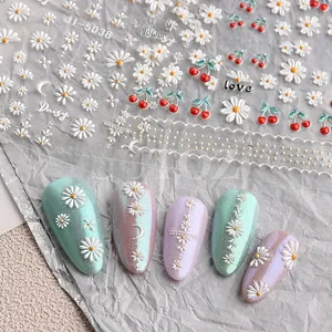 Detail of 5D embossed nail stickers featuring white daisy and red cherry designs