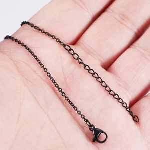Black stainless steel cross chain necklace with lobster clasp and extender shown on hand