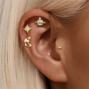 Close-up of gold s925 silver celestial stud earrings with stars and moon on ear